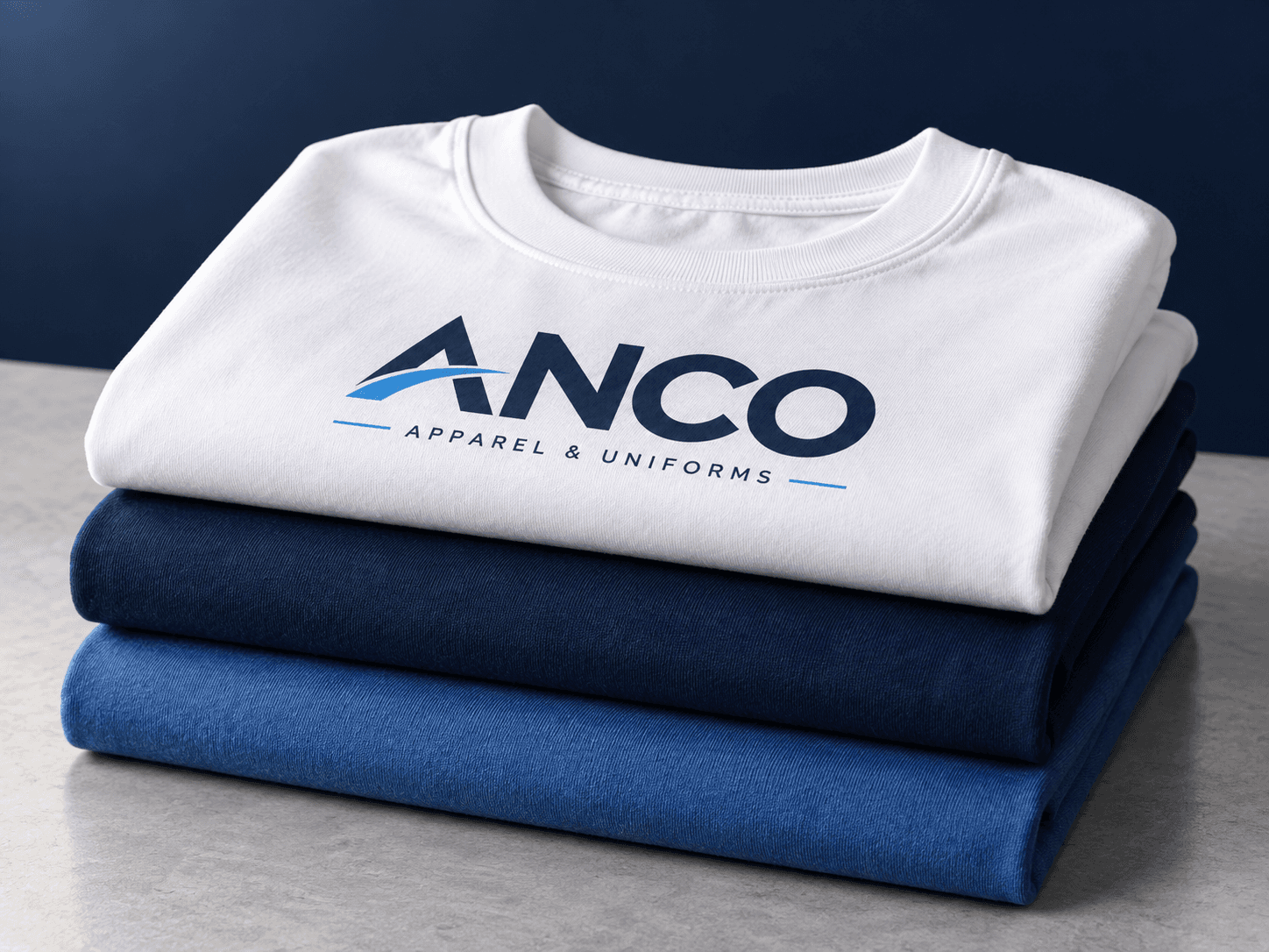 Folded white, navy and blue ANCO T-shirts